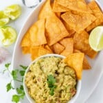 Dipping a corn tortilla chip in fresh guacamole.