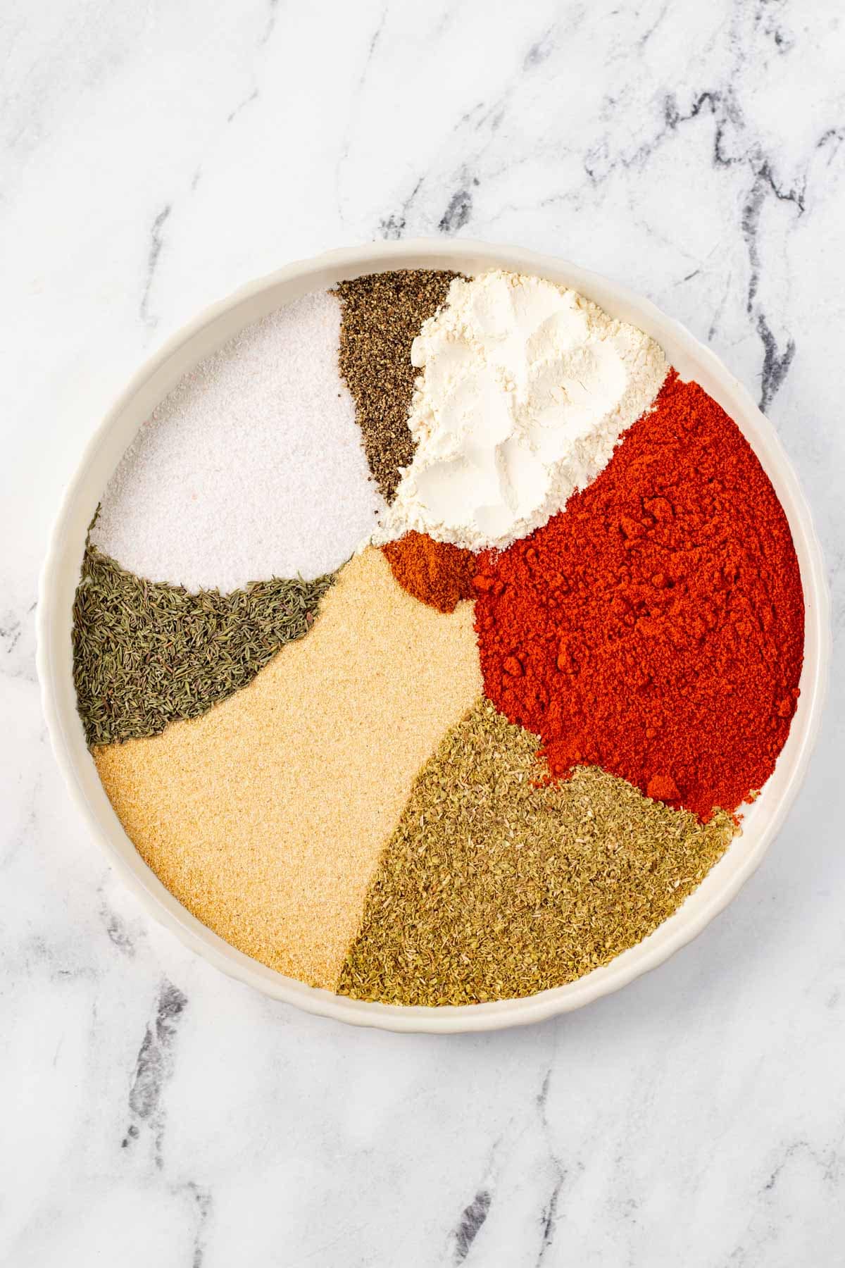 Spices spread out on a plate.