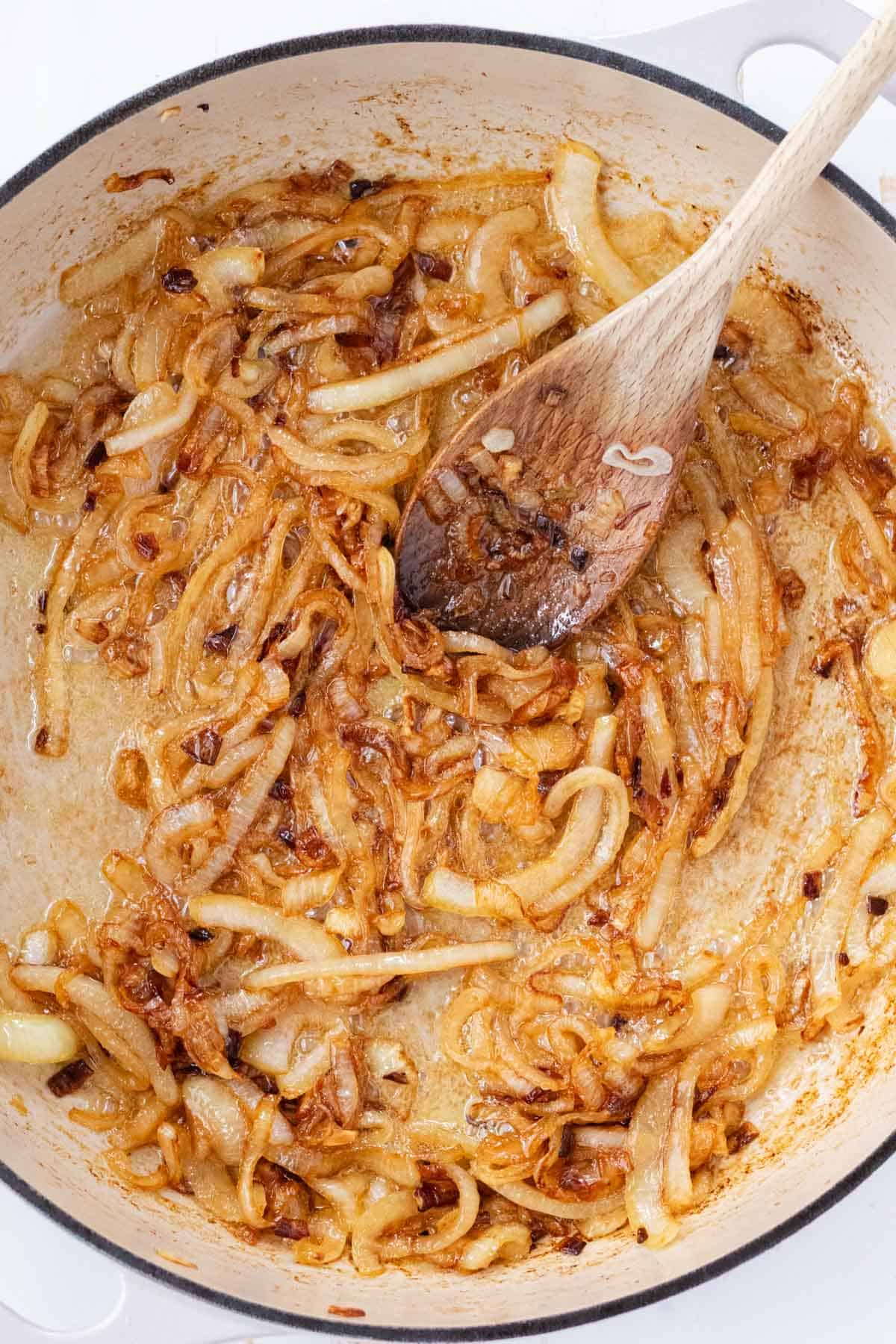 Golden brown caramelized onions in a large sauté pan.