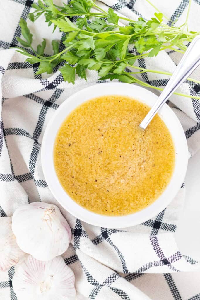 Adding the parmesan to the garlic butter sauce.