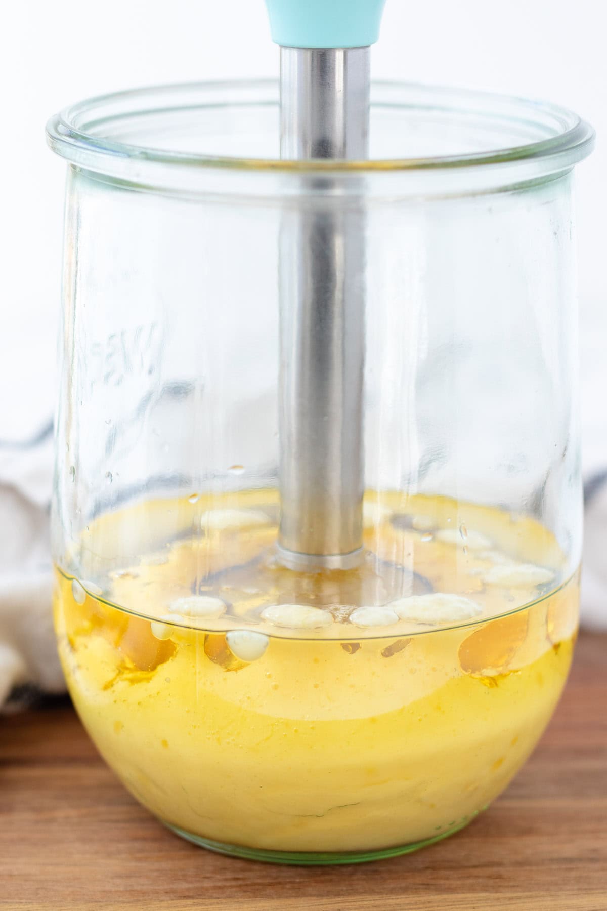 Starting the immersion blender, but keeping it on the bottom of the jar.