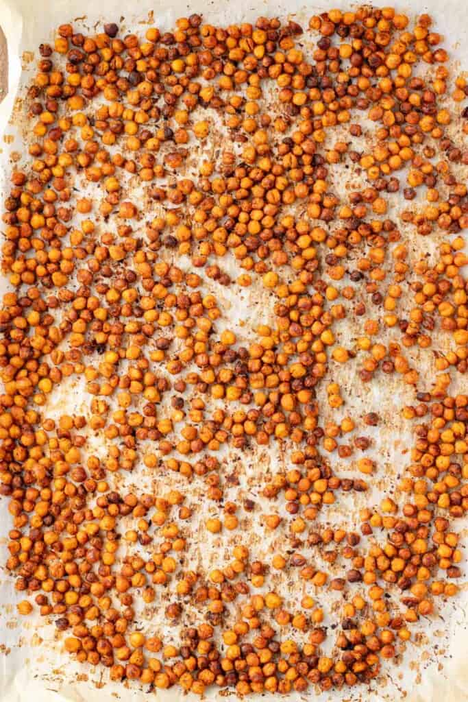 Baked buffalo chickpeas on a baking sheet.
