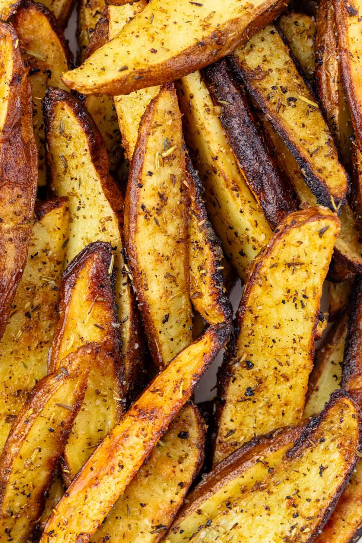 Baked greek lemon potatoes in a pile.