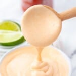 Homemade spicy mayo running off of a spoon.