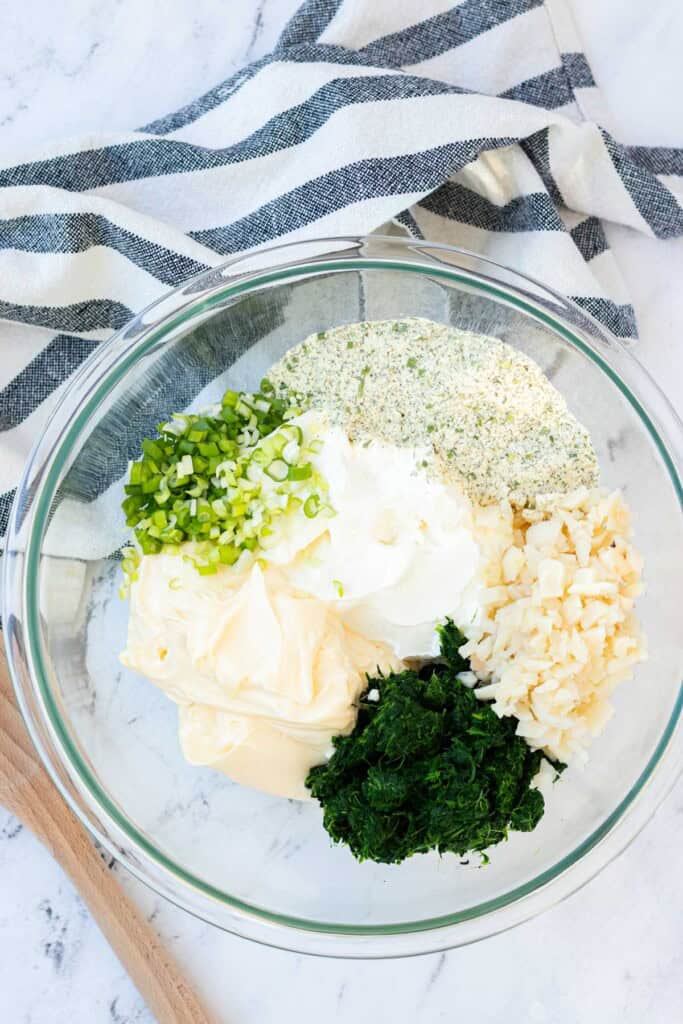 Adding all of the ingredients to a clear mixing bowl.