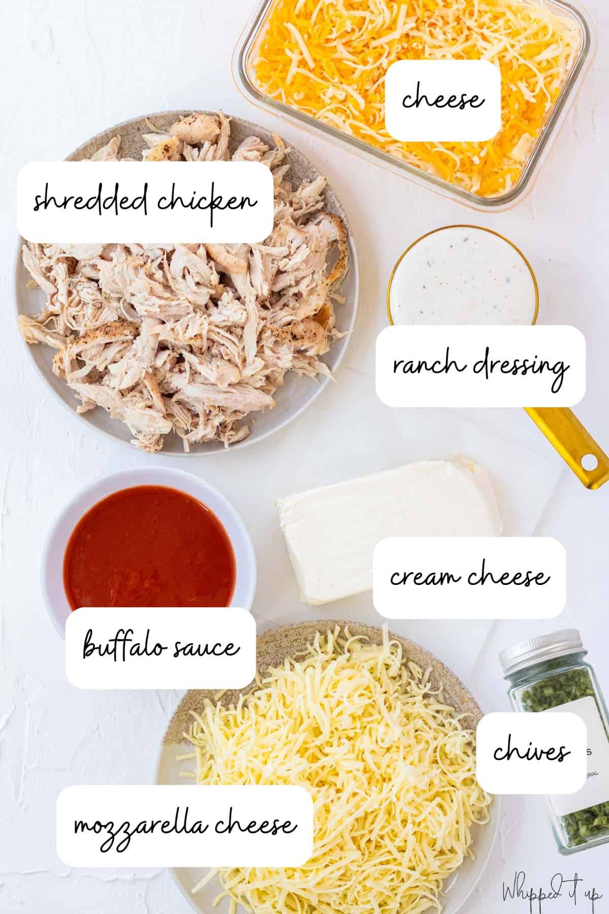 Ingredients for buffalo chicken dip measured on a white background.