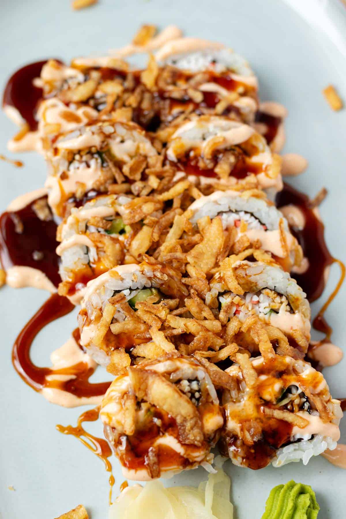 Eel sauce drizzled over sushi rolls.