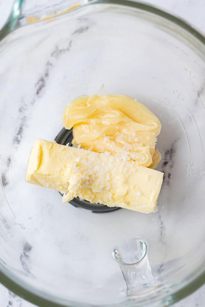 Butter, honey and salt in a glass mixing bowl.