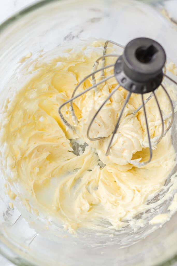 Whipped honey butter in a glass mixing bowl with the whisk attachment.