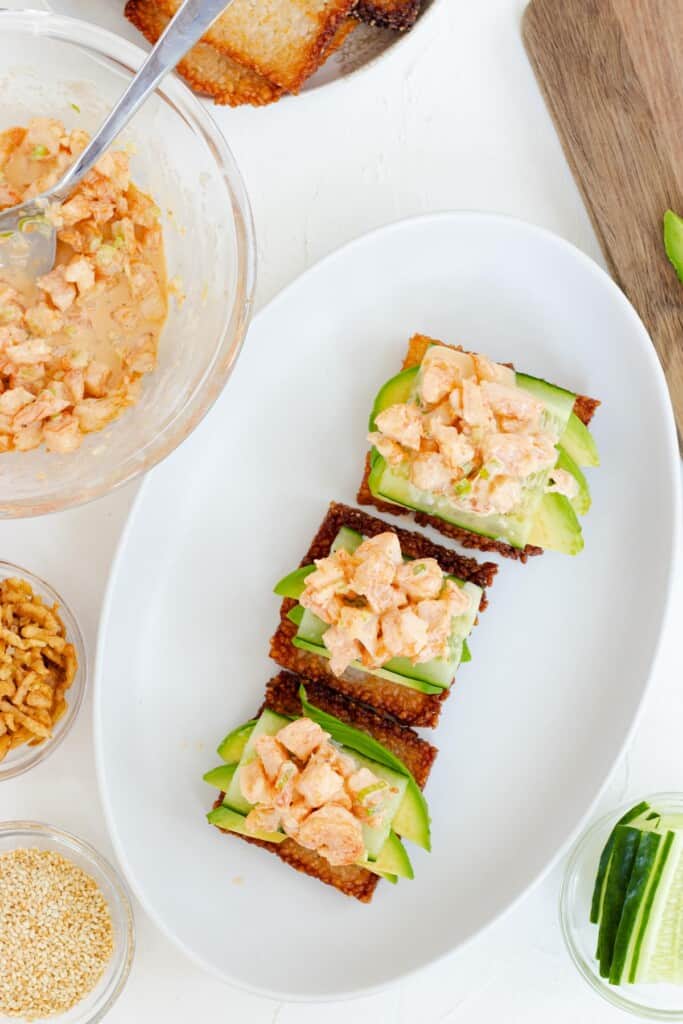 Piling the shrimp mixture on top of the cucumber.
