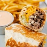 Big Mac wrap toasted on a plate with fries and a side of Big Mac sauce.