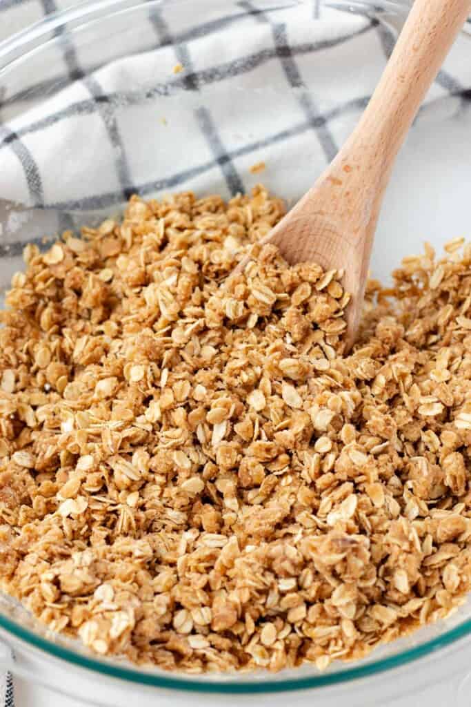 Mixing the brown sugar crisp topping in a glass bowl.