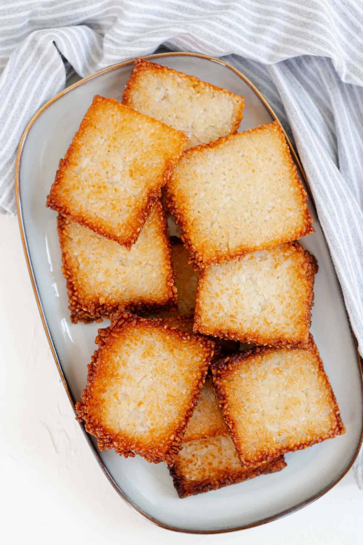 A blue plate fill of crispy rice squares.