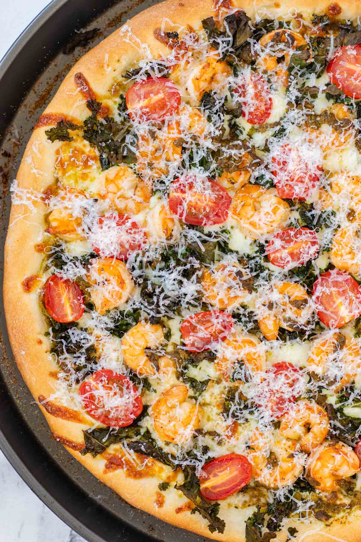Half of the pizza baked and in the pizza pan.