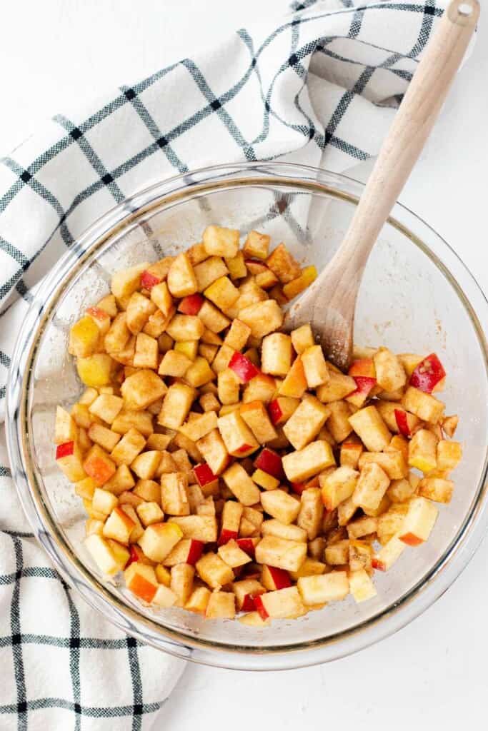 Stirring the apples with the spices, lemon juice, and sugar.