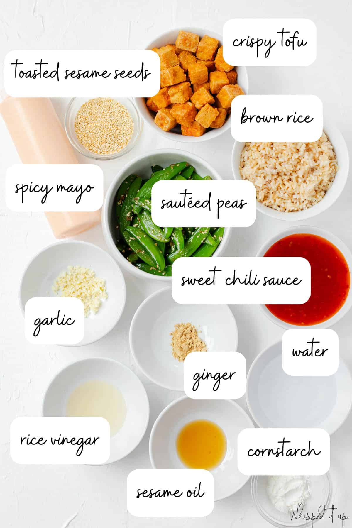 Ingredients to make bowls measured out into white bowls on a white countertop.