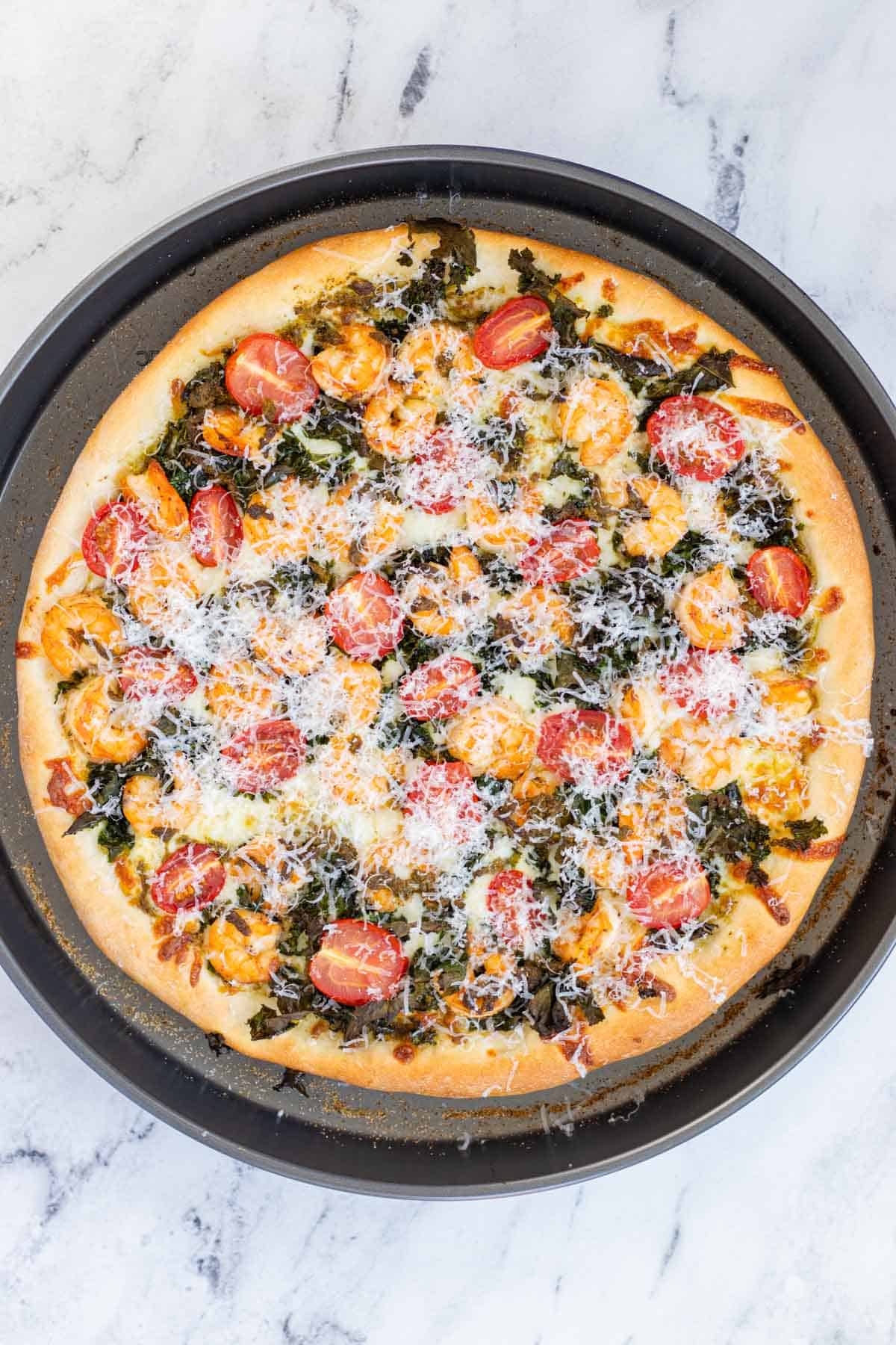 Baked pizza topped with freshly grated parmesan cheese.