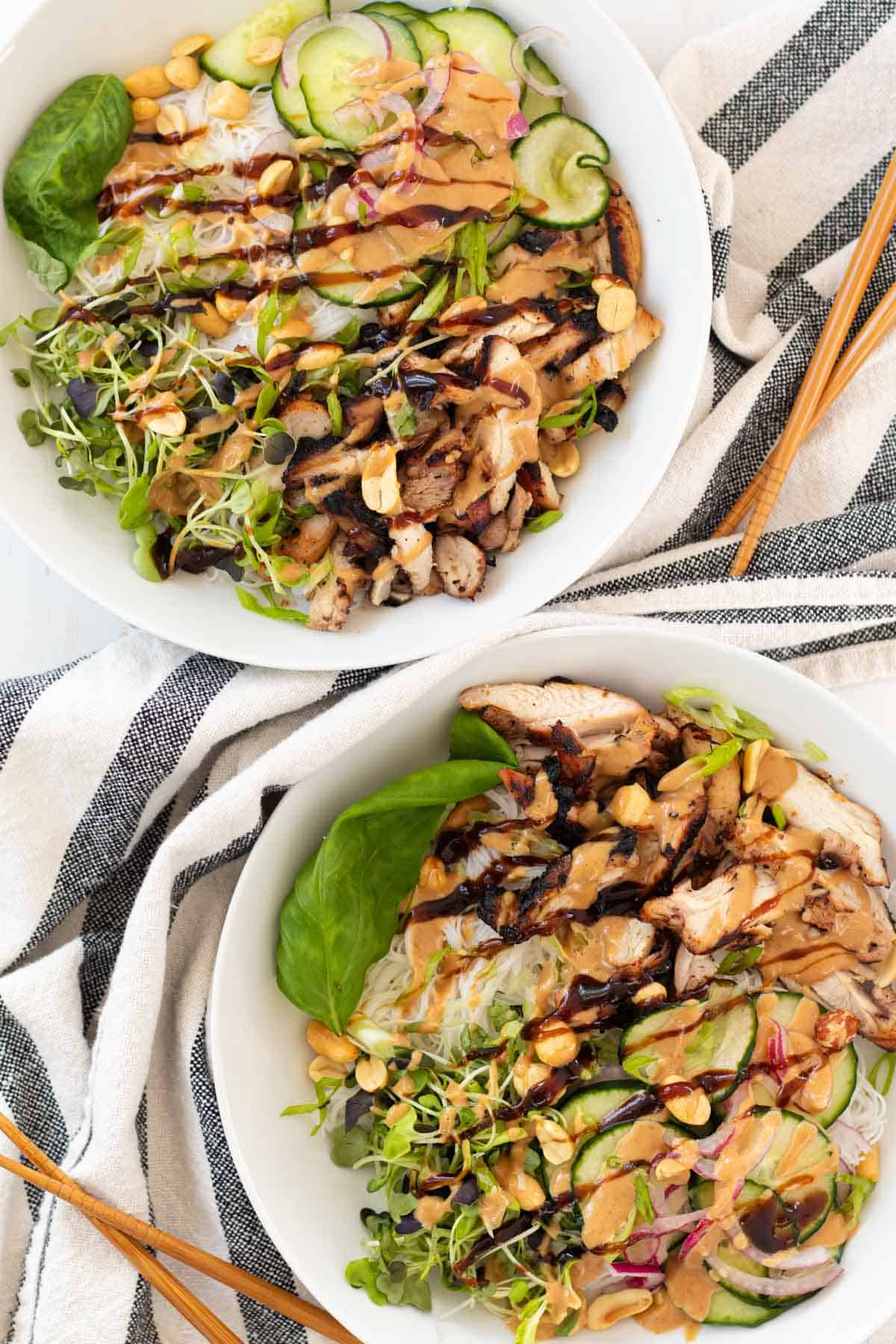 Two vermicelli noodle bowls with chopsticks.