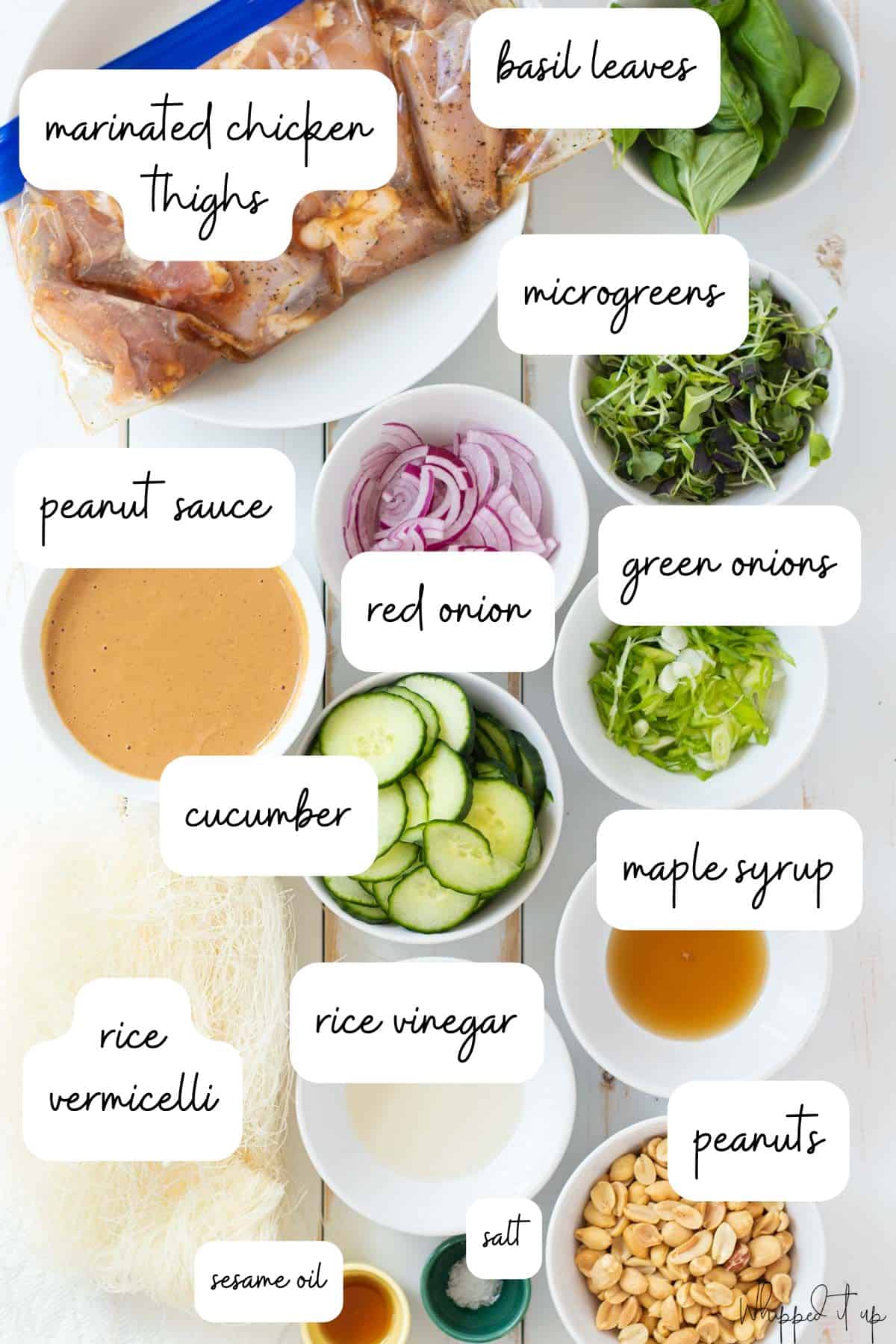 Ingredients to make the vermicelli noodle bowls measured out in white bowls on a white wood background.