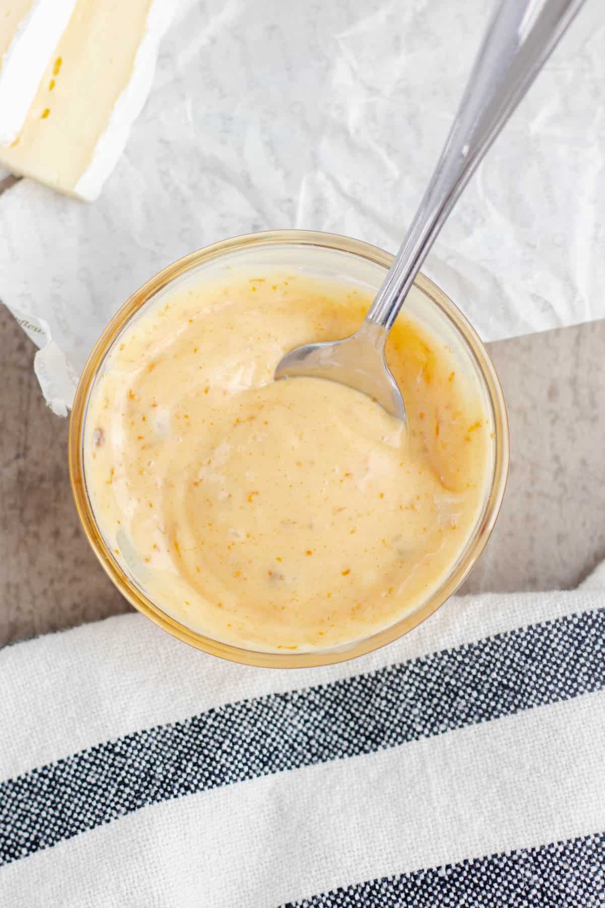 A spoon in a bowl of fig aioli.