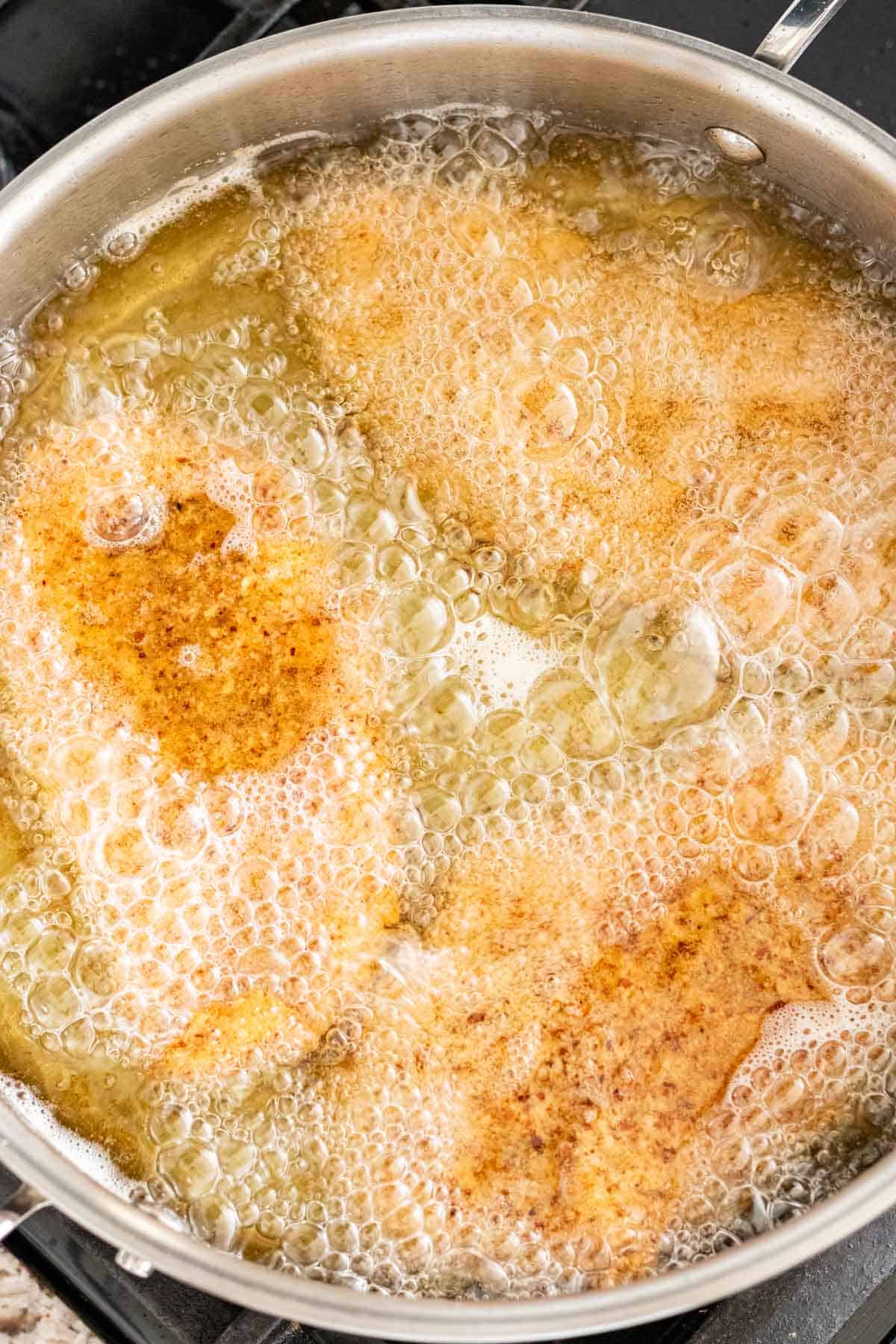 Frying the chicken cutlets in a deep skillet in cooking oil.